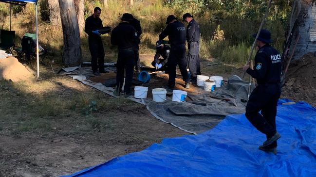 Police dig up the shallow grave where Mr Wong was buried. Picture: NSW Police