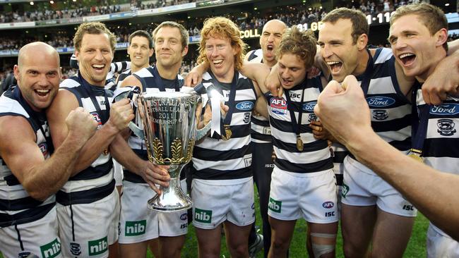 James Kelly (second from left) celebrates the 2011 premiership with Paul Chapman, Harry Taylor (background), Joel Corey, Cameron Ling, James Podsiadly, Mitch Duncan, Brad Ottens and Joel Selwood.