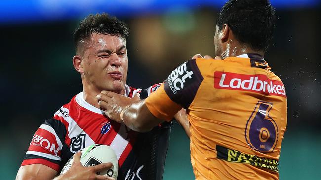 Roosters Joseph Manu looks to palm off Anthony Milford. Picture. Phil Hillyard