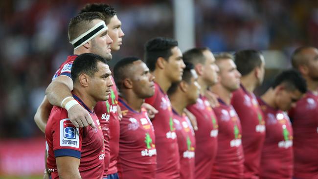 Reds player George Smith and his team have a moments silence as part of ANZAC commemorations during the round 10 Super Rugby game between the Queensland Reds and the Chiefs at Suncorp Stadium in Brisbane, Saturday, April 21, 2018. (AAP Image/Jono Searle) NO ARCHIVING, EDITORIAL USE ONLY