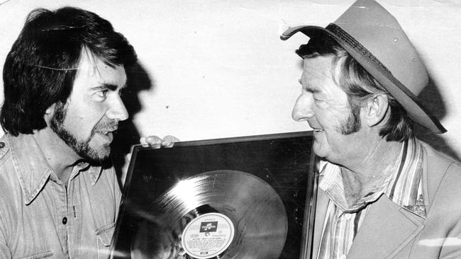 Neil Humphrys with Slim Dusty and his 50th framed gold record in 1977. Picture: Advertiser Library