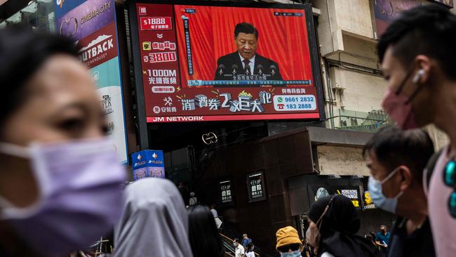 Chinese President Xi Jinping is seen on a TV in a street in Hong Kong as he delivers the opening speech of the ruling Communist Party’s 20th party congress in Beijing. Picture: AFP