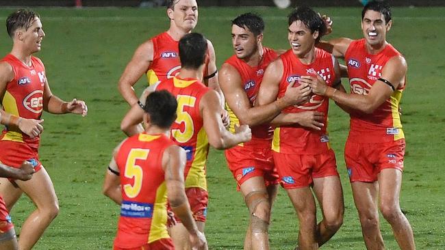 Jack Bowes (2nd right) of the Suns celebrates after scoring a goal during the round one AFL match between the Gold Coast Suns and the North Melbourne Kangaroos at Cazaly's Stadium on March 24, 2018 in Cairns, Australia. (Photo by Ian Hitchcock/Getty Images)