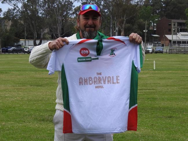 Mark De Luca holds up his milestone shirt. Picture: Bradbury CC