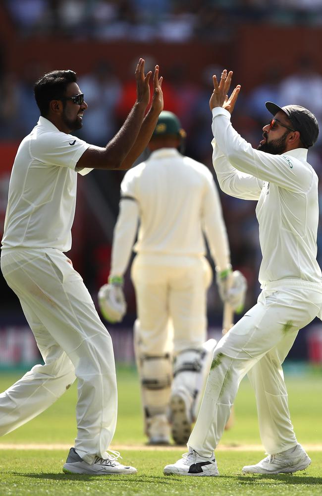 Virat Kohli of India celebrates after Ravi Ashwin took the wicket of Usman Khawaja of Australia during day four of the First Test in Adelaide. Aswin is out of the Second test. Picture: Ryan Pierse/Getty