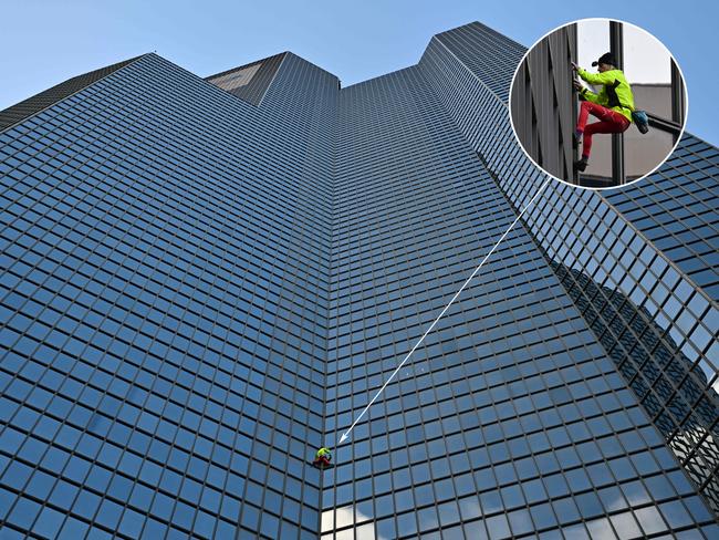 French skyscraper climber Alain Robert, known as the "French Spiderman", free-climbs the 187 metre-high Coupole Total tower in Paris to call for peace in Gaza. Picture: Miguel Medina/AFP