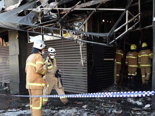 Fire investigators assess the scene this morning. Picture: Steve Tanner