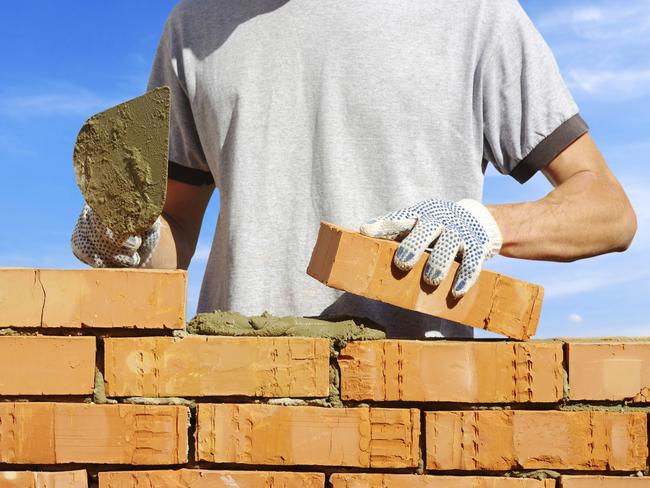 bricklayer laying bricks to make a wall for pink floyd economics paul syvret brexit