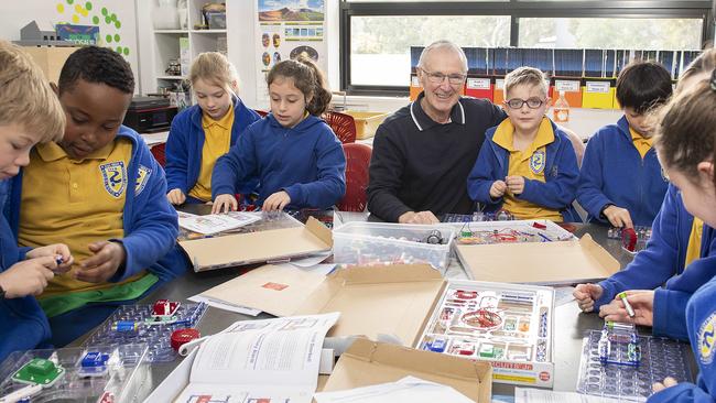 Teacher Peter Ruff has been recognised for his long service at Heidelberg Primary School. He's pictured with some Year 3 students. Picture: Ellen Smith