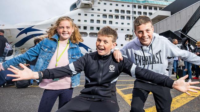 Cruise passengers Adelaide, 10, Hudson, 12, and Oakley Gurr, 13, in front of the P&amp;O Pacific Explorer at Outer Harbour. Picture: Tom Huntley