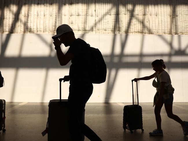 LOS ANGELES, CALIFORNIA - AUGUST 31: Travelers walk with their luggage in the international terminal at Los Angeles International Airport (LAX) on August 31, 2023 in Los Angeles, California. Labor Day weekend will cap off the busiest summer of airline travel on record in the U.S. with over 14 million passengers predicted to board flights, which will top pre-pandemic travel numbers. According to the FAA, today will be the busiest day of the holiday weekend with 52,203 flights scheduled in U.S. airspace.   Mario Tama/Getty Images/AFP (Photo by MARIO TAMA / GETTY IMAGES NORTH AMERICA / Getty Images via AFP)