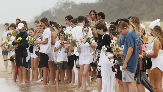 Balin Stewart’s friends line the beach at Buddina on Wednesday, January 26, 2022. Picture: Lachie Millard