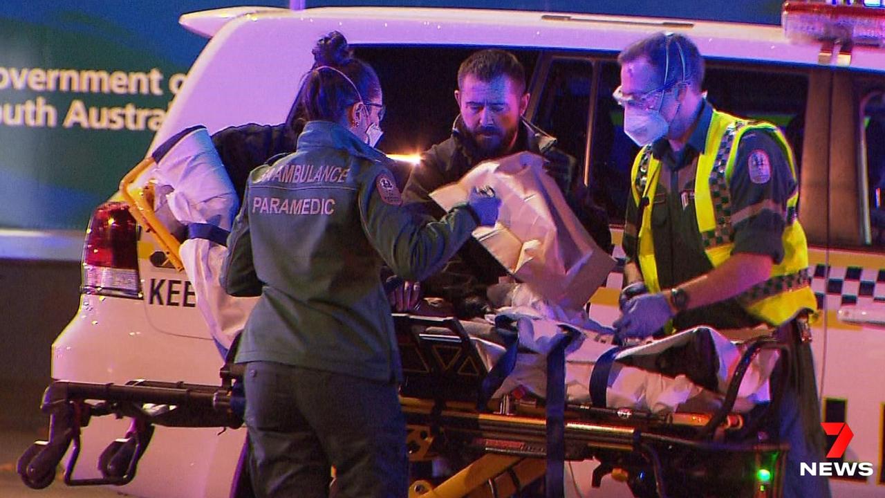 Paramedics remove an injured person from the scene of a fight in Adelaide. Picture: 7 NEWS