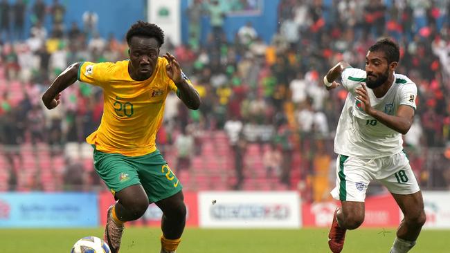 Socceroos winger Nestory Irankunda (left) tries to get the better of Bangladesh’s Isa Faysal in Dhaka. Picture: Thananuwat Srirasant/Getty Images