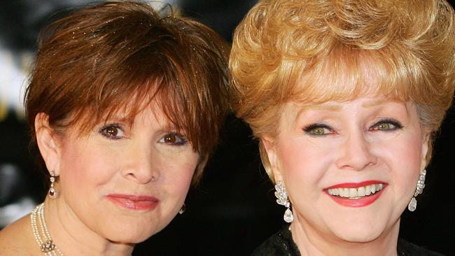 Carrie Fisher (L) and her mother, Debbie Reynolds, arriving for Dame Elizabeth Taylor's 75th birthday party in 2007. Picture: AFP