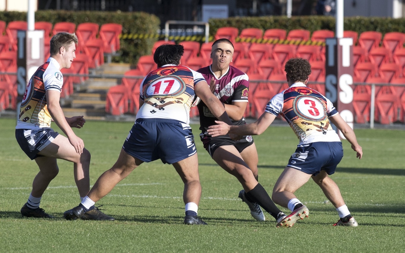 Marsden's Eli Tuli comes face to face with Marcus Waters and Blake Cesari, St Mary's.