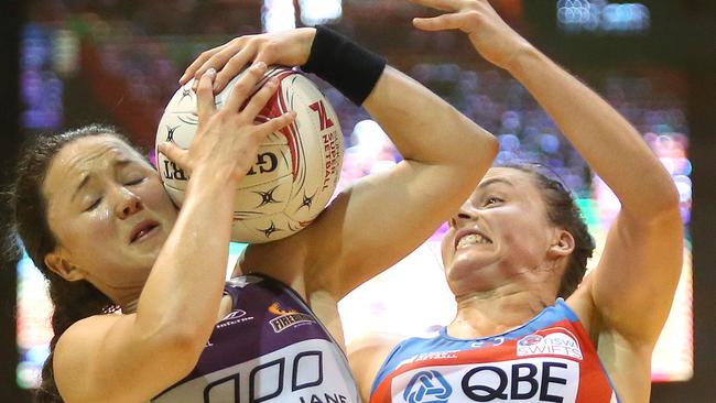 The Firebirds’ Caitlyn Nevins (left) tussles with the Swifts’ Paige Hadley on Friday night.