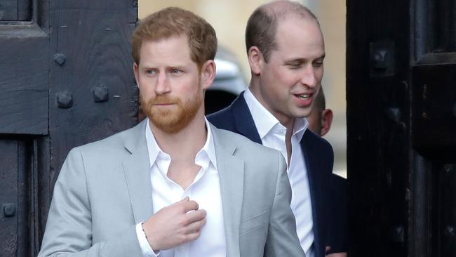 Harry (left, with brother Prince William) is preparing legal action against the UK government. Picture: AFP