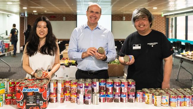 Vice-chancellor George Williams flanked by student community program co-ordinator Miranda Zhang and student Richard Xu. Picture: Wendy Chung