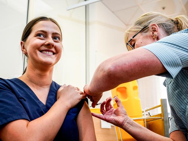 WCH vaccine hub presser, Emergency Department nurse Emily Hooper gets her Pfizer vaccination from Nurse Unit Manager Maryanne Attard, Tuesday March 2, 2021 - pic Mike Burton