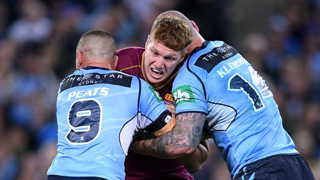 Dylan Napa takes on Nathan Peats and David Klemmer in 2017. Picture: AAP Image/Dan Himbrechts