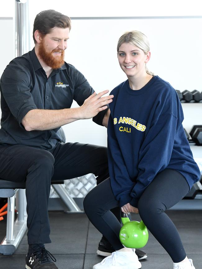 Holly Scott overcomes daily struggles to learn how to get back on her feet again with the help of a team of health experts including exercise physiologist Stephen Bateman. Picture: Tom Huntley