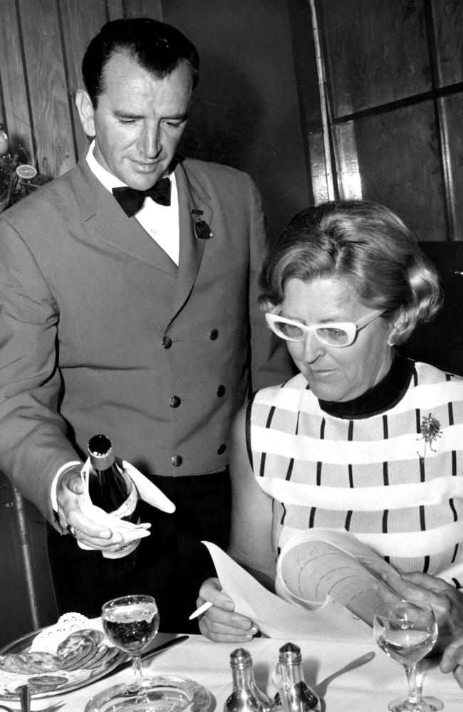 Waiter Leo Sater serves wine to Mrs P Black at the Criterion Hotel in 1970.