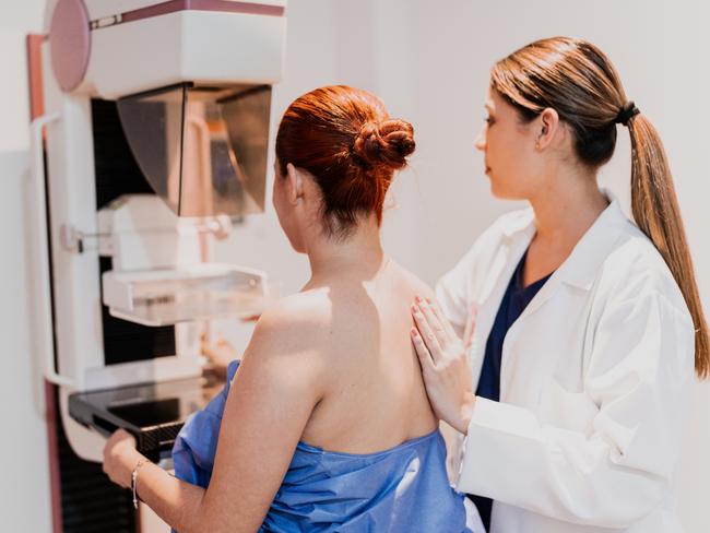 Doctor doing mammogram exam on patient at hospital