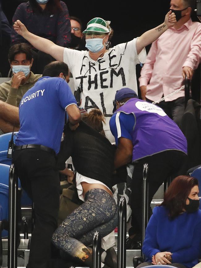 Protesters are ejected by security during the Australian Open men’s singles final. Picture: Getty Images