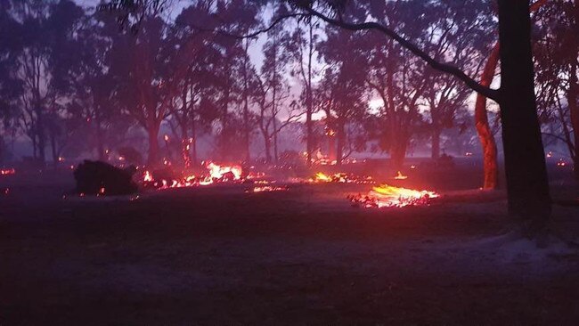 A backyard ablaze during the height of the Luncindale bushfire. Picture: Sue Jones