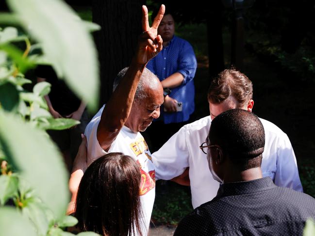 Bill Cosby flashes a "V" sign outside his house as he celebrates his release. Picture: Reuters