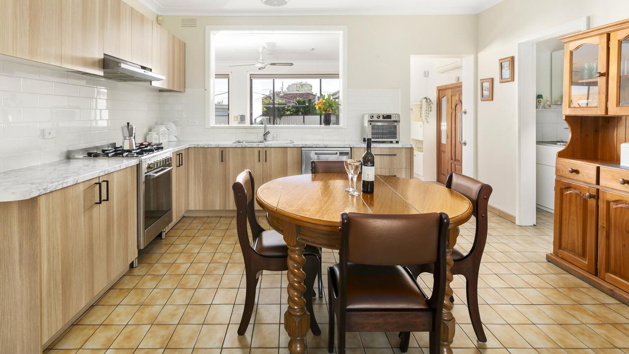 The updated kitchen is equipped with stainless-steel appliancs, and a serving window to the family room.