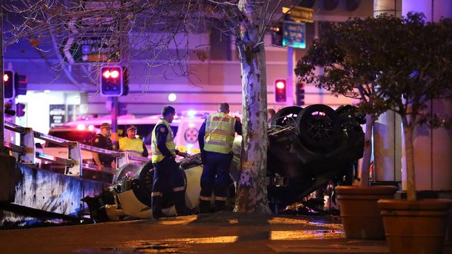 A police officer pulled a seriously injured man from the car. Picture: Steve Tyson