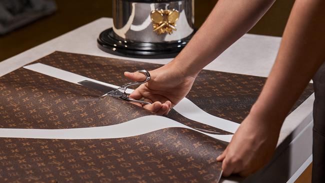 Louis Vuitton artisans cutting monogrammed leather