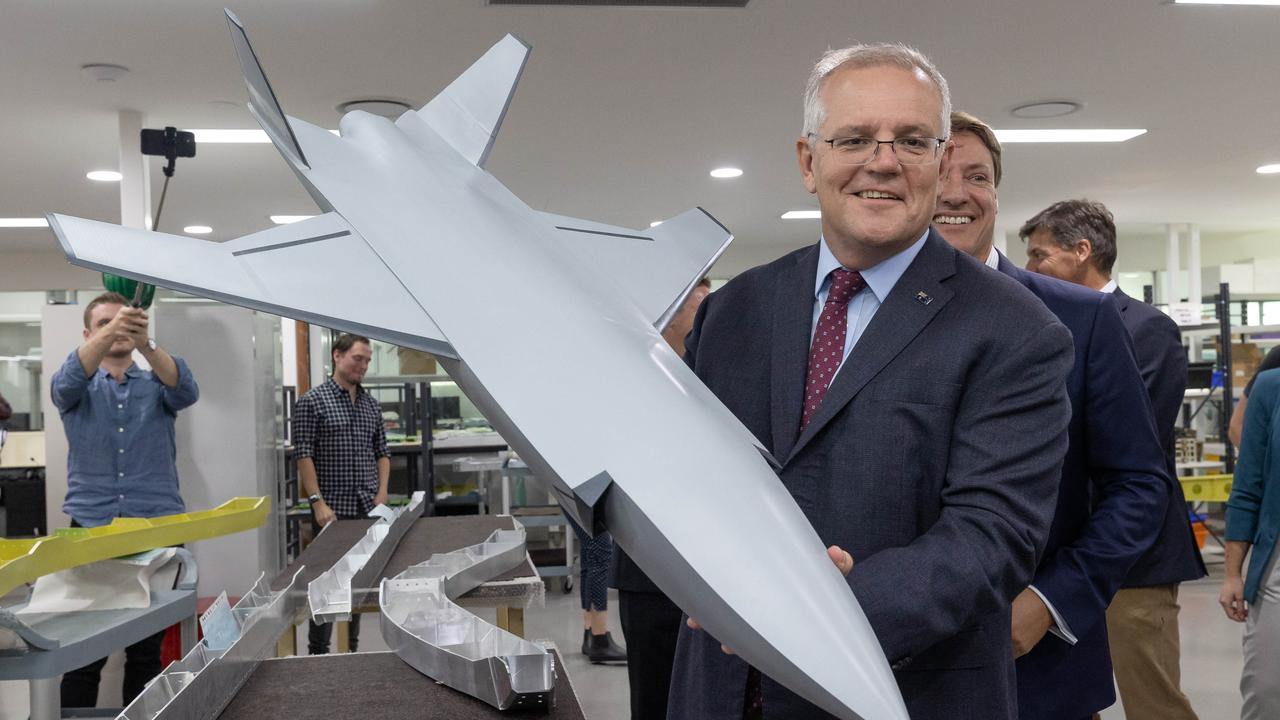 Scott Morrison lifts a scale model of combat drone, while visits Ferra Engineering, a defence manufacturing business in the Brisbane electorate of Bonner. Picture: Jason Edwards