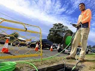 WHERE'S THE NET: A worker laying down fibre optic cable as part of the NBN rollout. Picture: David Nielsen