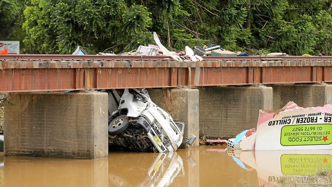 A white pantec truck is smashed to pieces under the railway culvert at Green Hills on the Tweed Valley Way at Green Hills after heavy flooding washed around 25 cars off the road surface during the rain deluge. Photo: Scott Powick/ Tweed Daily News