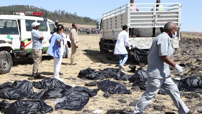 Rescue team walk past collected bodies in bags at the crash site of Ethiopia Airlines near Bishoftu, a town some 60 kilometres southeast of Addis Ababa, Ethiopia. Picture: Michael Tewelde/AFP.