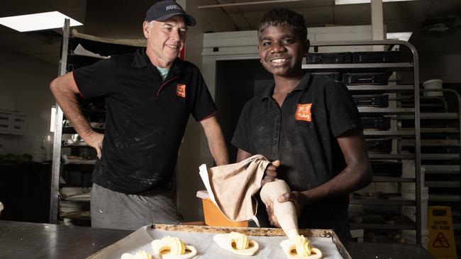 Scotty Goodwin, 14, who was “abandoned by his alcoholic mother” at five days old, working at NT Bakery with baker and Alice Springs advocate Darren Clark. Picture: Liam Mendes