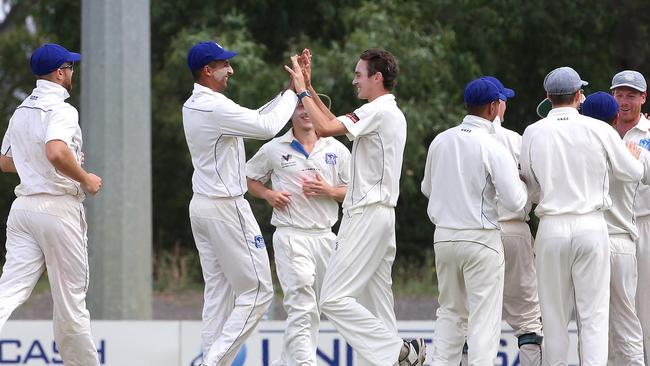 Jordan Buckingham (centre) celebrates a wicket last summer. Picture: Hamish Blair.