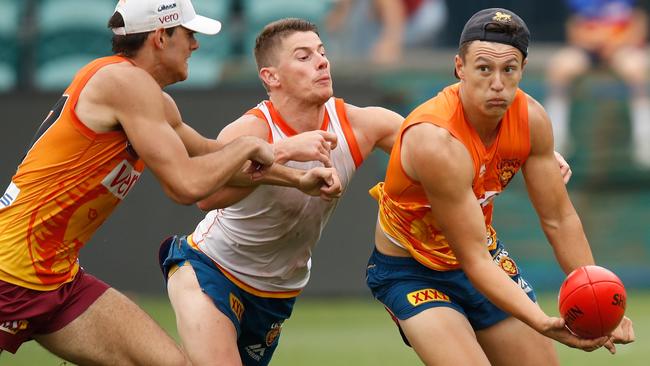 Hugh McCluggage, right, is tackled by team-mate Dayne Zorko.