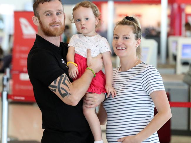 World boxing title challenger Dennis Hogan with his pregnant wife Brideen and daughter Aria at the Brisbane airport. Photographer: Liam Kidston.