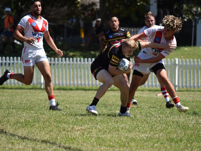 Luke Hanson is tackled by Shadi Hammoud. Picture: Sean Teuma/NewsLocal