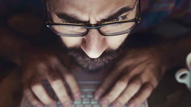 Computer hacker stealing information with laptop. Picture istock