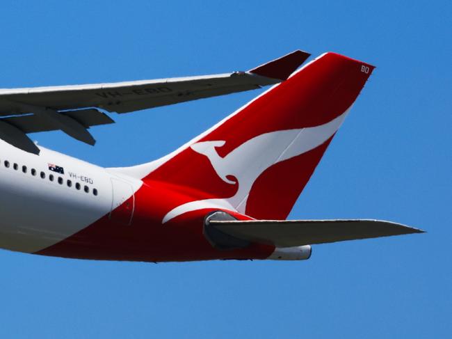 SYDNEY, AUSTRALIA - FEBRUARY 22: The tail of a Qantas plane is seen at take off from Sydney International Airport on February 22, 2024 in Sydney, Australia. Qantas has demonstrated a significant financial turnaround, reporting a record $2.47 billion profit for the 2022-23 fiscal year, marking a stark change from the previous year's $1.86 billion loss. The airline's strong performance was attributed to robust travel demand and high ticket prices, with domestic earnings before interest and taxes (EBIT) jumping to 18.2%, representing a 50% increase in profit margins over the past six years. The company's return on invested capital also increased to 103.6%, reflecting its improved financial position and operational performance. (Photo by Jenny Evans/Getty Images)