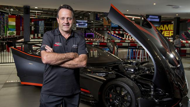 Tony Quinn with his Aston Martin Vulcan, a car limited to 24 in the world, parked at his business Game Over Gold Coast at Helensvale. Picture: Jerad Williams