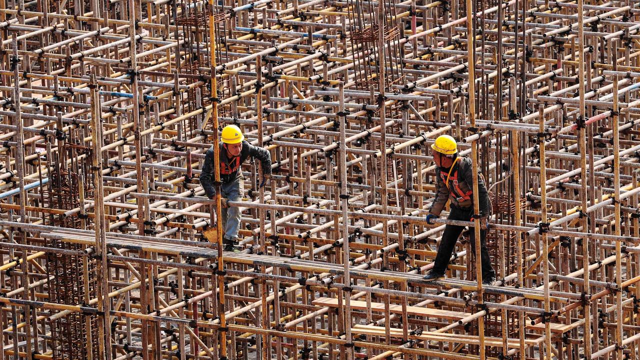 Workers on a construction site in southwestern China's Chongqing municipality. Picture: AFP) / China Out