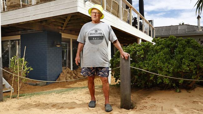 Jack Leary at his Avoca Beach home where the king tide brought sand all the way up to the front door. Picture: Richard Dobson