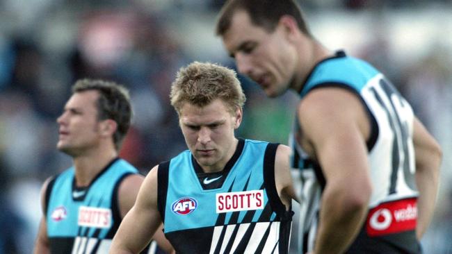 Kane Cornes, centre, with Warren Tredrea after Port Adelaide’s 2003 qualifying final loss to Sydney.