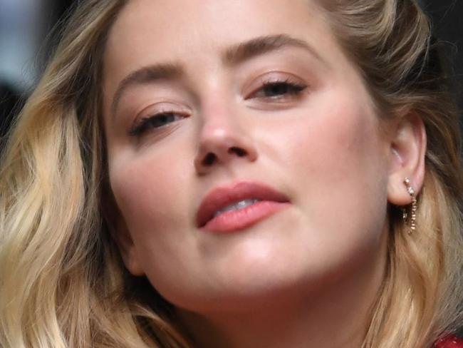 US actress Amber Heard arrives on day thirteen of the libel trial by her former husband US actor Johnny Depp against News Group Newspapers (NGN), at the High Court in London, on July 23, 2020. - US actress Amber Heard on Wednesday said her ex-husband Johnny Depp threw dozens of bottles at her "like grenades", as she gave evidence for a third day at his London libel action. (Photo by DANIEL LEAL-OLIVAS / AFP)